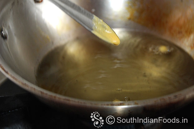 Heat oil, take batter in a spoon, check consistency