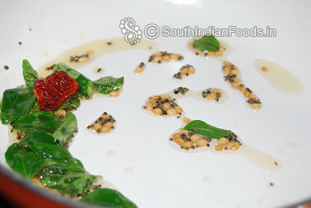 Heat coconut oil in a pan, add mustard, urad dal, dry red chilli, green chilli and curry leaves fry 