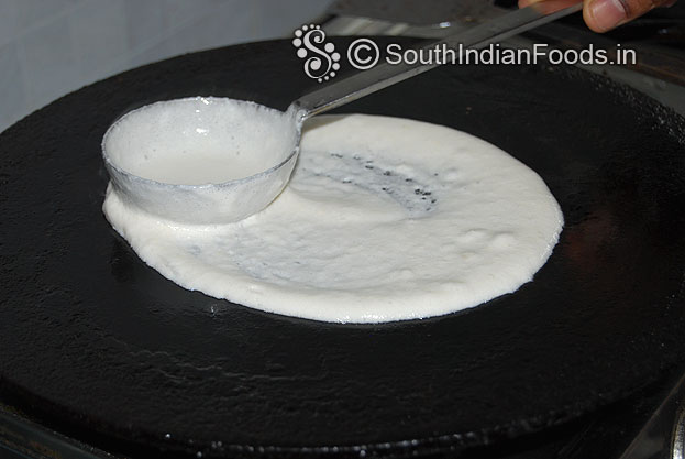 Heat iron dosa tawa, sprinkle water, pour batter