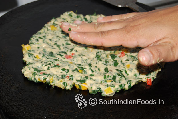 Heat iron dosa tawa, place one handful of dough, evenly spread