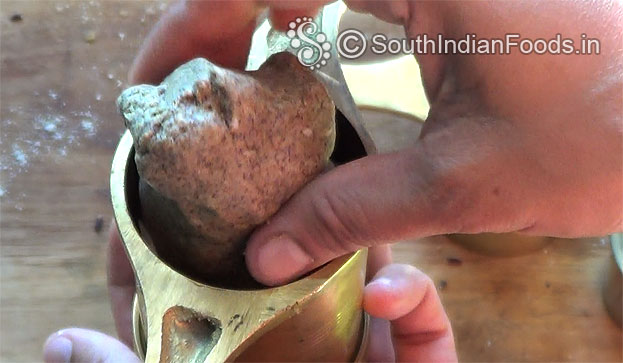 Place handful dough in a murukku kuzhal