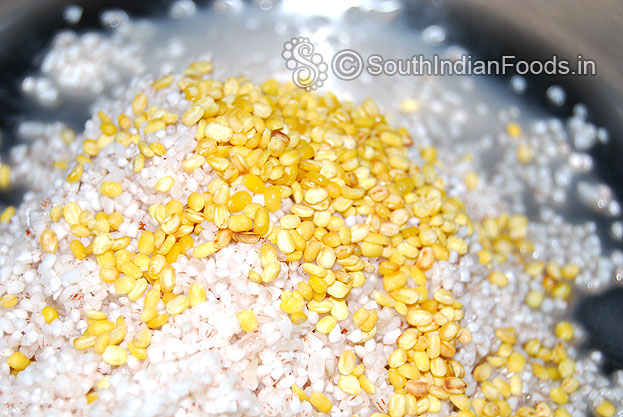In a pressure cooker, add soaked red rice & moong dal