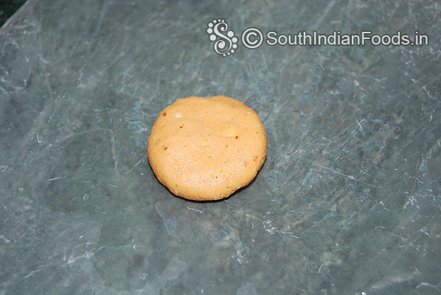 Place plastic cover on the chapati making stone then place lemon size ball