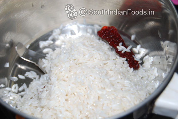 Put rice, dry red chilli, in a mixer jar finely grind with enough water