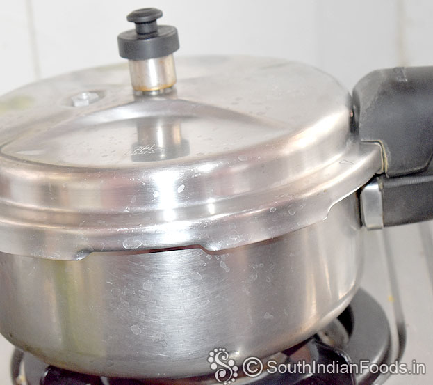 Cover lid, cook for 4 to 5 whistles