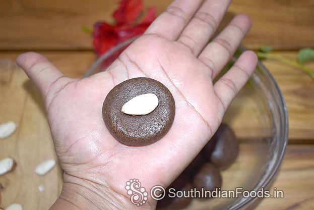 Place half almond