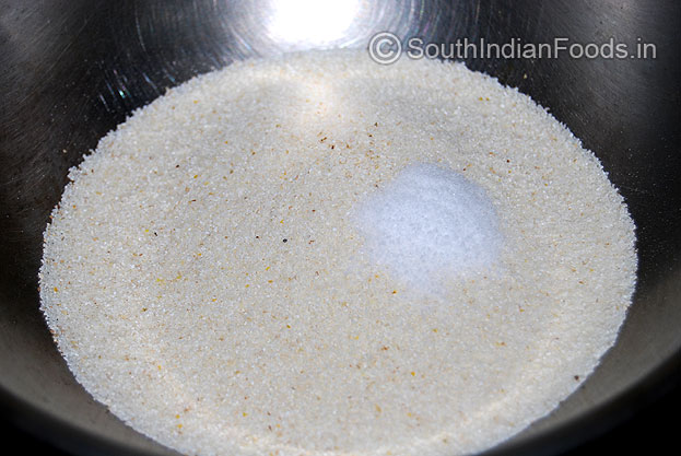 In a bowl add white rava & salt