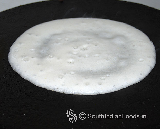 Heat dosa tawa, pour batter, gently spread