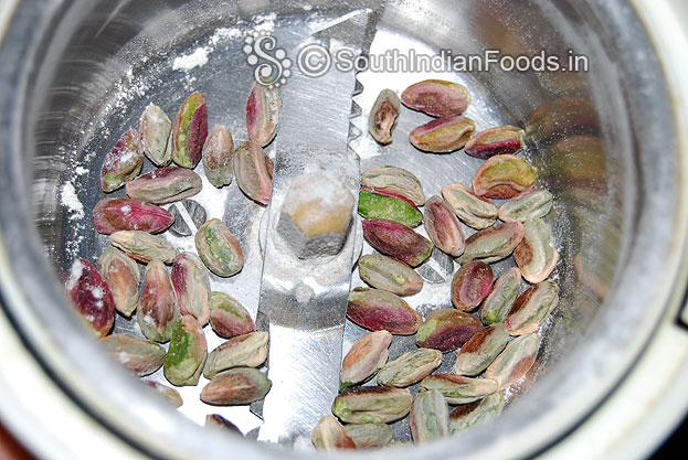 In a mixer jar add pistachios & coarsely grind.