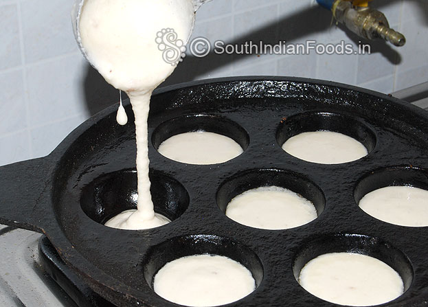 Heat iron paniyaram tawa, grease with ghee then pour batter