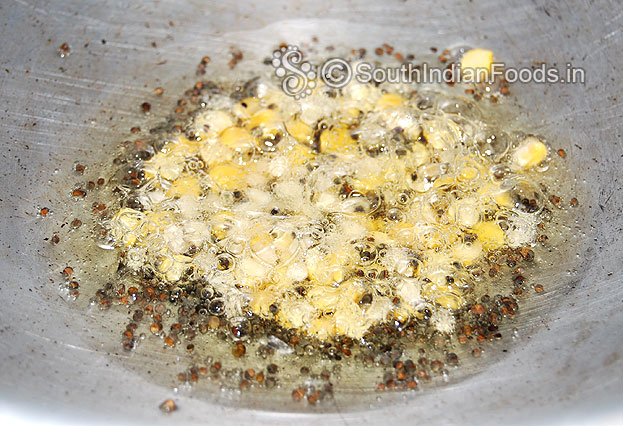 Heat oil in a pan add mustard, bengal gram & urad dal